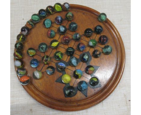 A Victorian walnut double sided solitaire board, complete with marbles