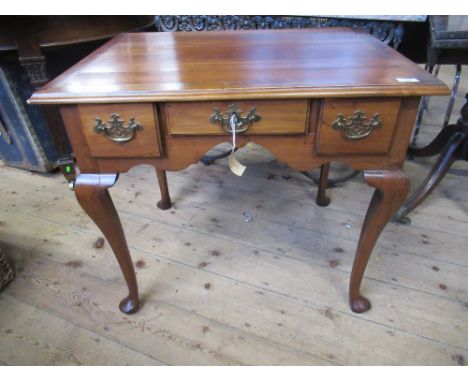 An 18th century Georgian fruitwood three drawer lowboy, standing on cabriole legs, with pad feet, having original Chippendale