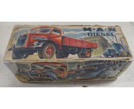 A German Arnold Toys M.A.N. diesel clockwork tinplate and plastic tipper truck, 1950s, with key, original box but with damage