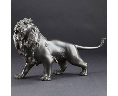 Japanese Showa bronze lion with inlaid amber eyes. Incised signature. Height: 6 1/2 in x width: 13 in x depth: 4 in.