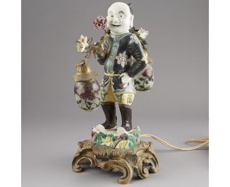 Chinese porcelain figurine of a boy, made into a lamp in France, c. 19th century. The lamp features a gilt bronze Rococo base