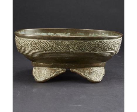 Japanese bronze bonsai planter on four shaped feet, with seigaiha pattern along the feet and underside. Patterned bands along