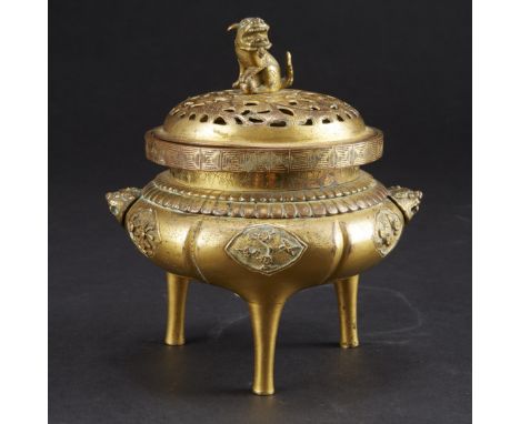 Chinese gilt bronze censer dating from the late 18th or early 19th century, decorated with a foo dog finial and carved floral