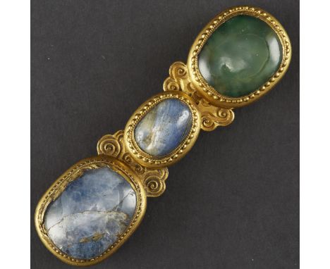 Fine 18th century Chinese buckle, made of gilt bronze, sapphire, and glass. Each cabochon is set with in roped and pearled bo