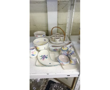 A collection of various white bodied Poole Pottery items including an egg cup set and stand, various cruets and other items.