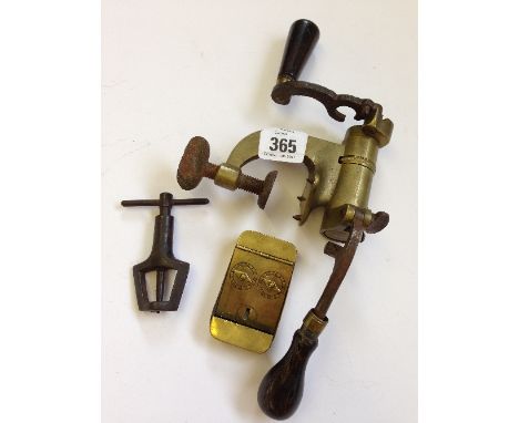 A brass bullet mould together with a small brass counter and one other shooting related item.