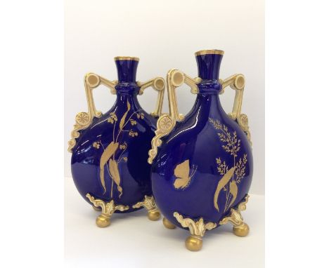 A pair of 19th century Minton style twin handled Moon Flask vases with enamelled gilt insect and leaf applied decoration on d