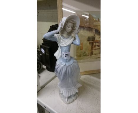 A Lladro china figure modelled as a Young Girl wearing a bonnet and scarf.