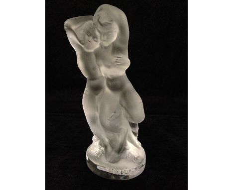 A Lalique France frosted glass model of two naked female figures on circular tree trunk base, incised script Lalique France.