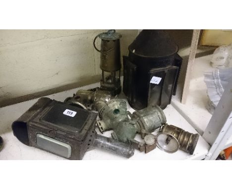 A collection of various early 20th century cycle lamps, lanterns and a Protector, Eccles brass miner's lamp.
