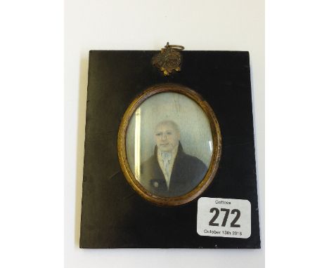 A framed miniature on ivory: Portrait of a man wearing black jacket.