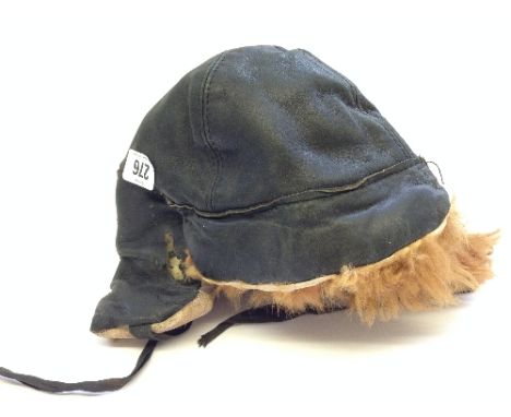 A WWII leather and wool lined flying helmet with peak and ear protectors  by Charles Markson Ltd (size 6 3/4), internal label