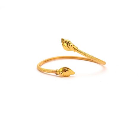 A yellow metal stylised torque bangle, indistinctly stamped, weight approx 10.2g