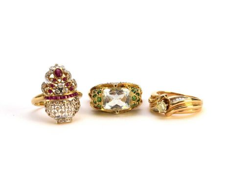 A single stone diamond ring, with baguette cut diamond set crossover shoulders, size N, stamped '14kt', a ruby and diamond st