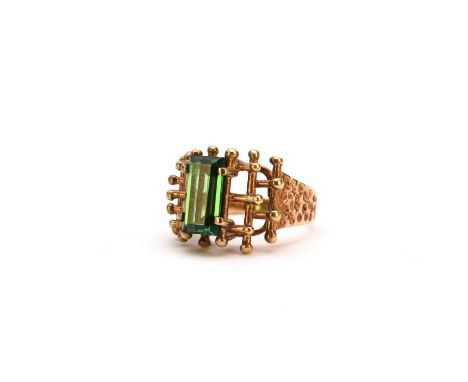 A garnet topped doublet dress ring, the rectangular green doublet claw set to abstract mount with textured tapering shoulders