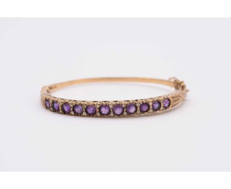 A 9ct gold amethyst and diamond hinged bangle, the push clasp with attached safety catch, weight approx 11g