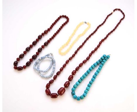 A collection of fourteen bead necklaces, to include; a graduated malachite example, two cherry red necklaces, a dyed jade exa