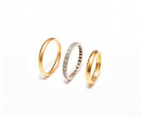 Two 22ct gold plain polished wedding bands, sizes I and P, total weight approx 8.8g, together with a diamond set eternity rin