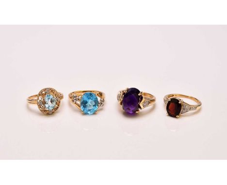 Two blue topaz rings, each size N and stamped '14k', together with an amethyst and diamond ring, size N 1/2, stamped '14k' an