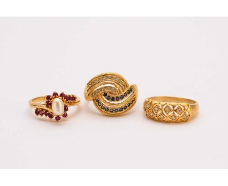 A sapphire and diamond stylised crossover ring, stamped ‘22k’, size S, together with a freshwater pearl and ruby crossover ri