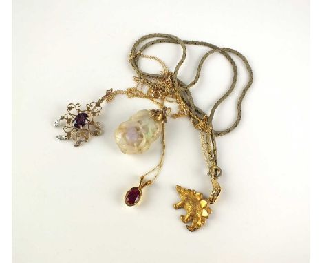 A carved jade pendant on chain, stamped ‘14k’, together with a yellow metal Dinosaur pendant on plated chain, a synthetic rub