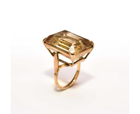 A large citrine single stone ring, the rectangular faceted citrine claw set in yellow metal, the shank stamped '9ct', ring si