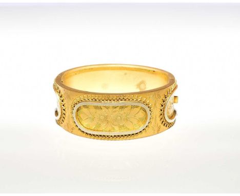 A late 19th century gilt hinged bangle, with bright cut engraved and applied wirework decoration, presented within case