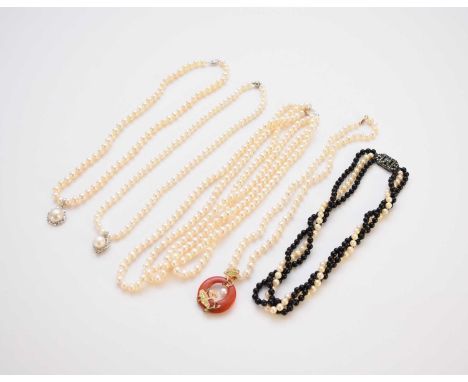 A collection of seven cultured pearl necklaces, comprising; a uniform three strand example, a single strand example with hear