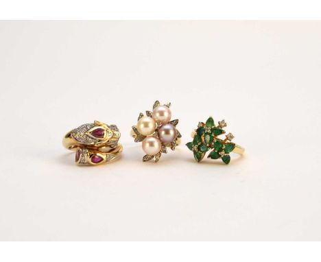 An emerald and diamond floral cluster ring, stamped '585', ring size N, together with a ruby and diamond stylised panther rin