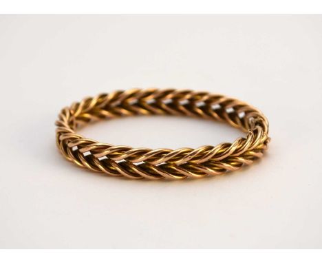 A yellow metal hinged bangle, of stylised double rope twist form, with push clasp, not stamped, inner dimensions approx 57mm 