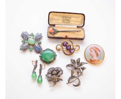 A yellow metal and green enamel brooch with figural decoration, together with a mid-19th century black enamel and seed pearl 