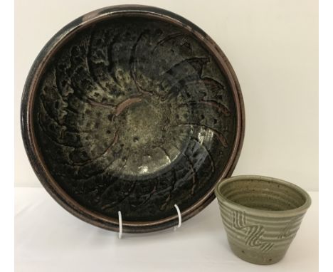 2 pieces of 20th century studio pottery. A David Leach, Lowerdown Cross bowl.In Tenmoku &amp; ash glaze with finger wiped dec