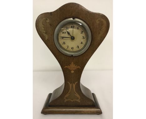 A wooden inlaid alarm clock with Art Nouveau style decoration. In working order.Approx. H20cm.