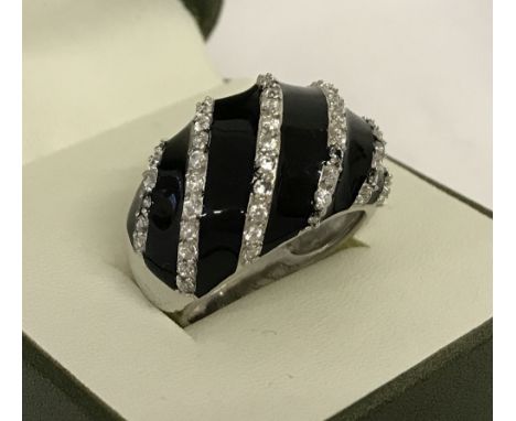 A ladies black enamel and clear stone set dome style dress ring.Stamped '925' to inside of band.Size R