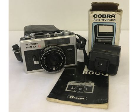 A vintage Ricoh 500G camera complete with instruction booklet and case.Together with a boxed Cobra Auto 150 flash unit.