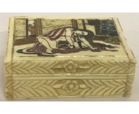 A small bone hinge lidded trinket box with carved detail to sides and erotic scene carved to lid.Approx. 2cm x 4cm x 5.5cm.