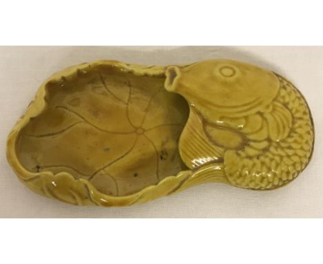 A small ceramic Chinese brush washer, in yellow glaze, with fish detail.Approx. 11cm long.