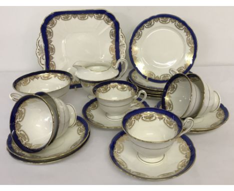 A collection of blue and gold Shelley Tea ware.Comprising: sandwich plate, 6 cups and saucers 6 cake plates, milk jug and sug