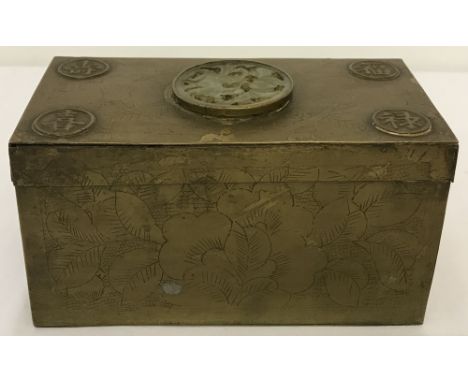 A vintage brass encased Chinese wooden box with jade roundel set to lid.Floral hammered detail to sides and lid.Approx. 9cm x