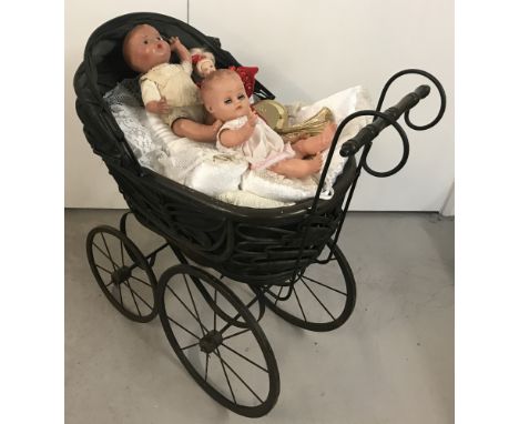 A reproduction vintage style dolls pram with lace edge pillow and covers.Together with 3 vintage and collectors dolls.