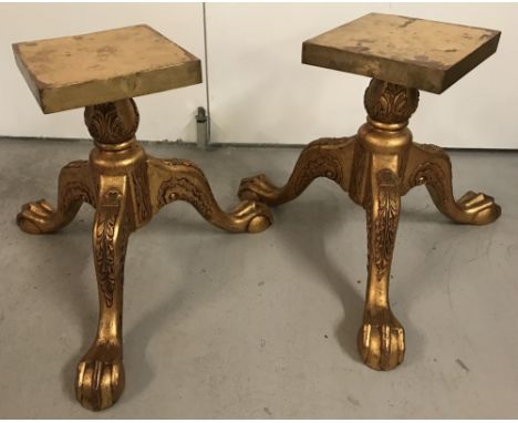 A pair of gilt painted wooden claw and ball feet tripod display stands.Both with carved detail to legs.Approx. 41cm tall.