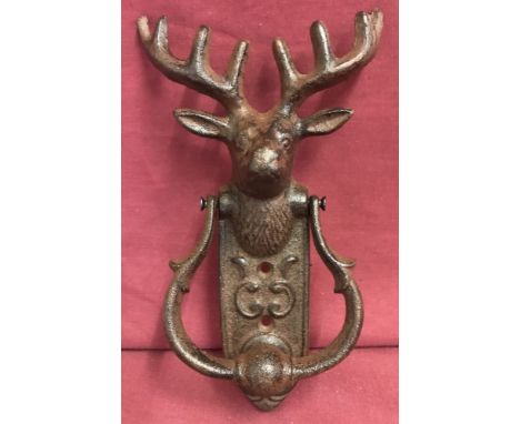 A cast iron stag head door knocker with scroll detail to fixing plate.Approx. 24cm x 14cm.