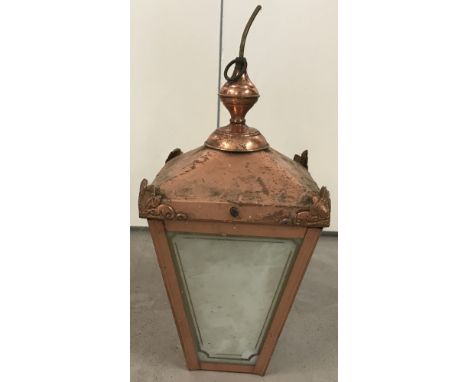 A copper ceiling porch light with brass hanging ring.In lantern style with corner detail, complete with glass.Approx. 42cm ta