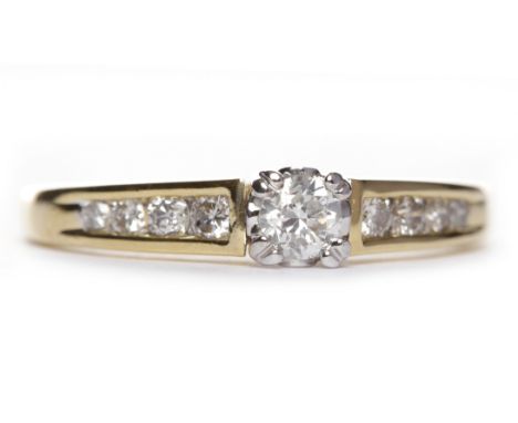 DIAMOND SOLITAIRE RINGthe four claw set round brilliant cut diamond of approximately 0.20 carats on tapered channel set diamo