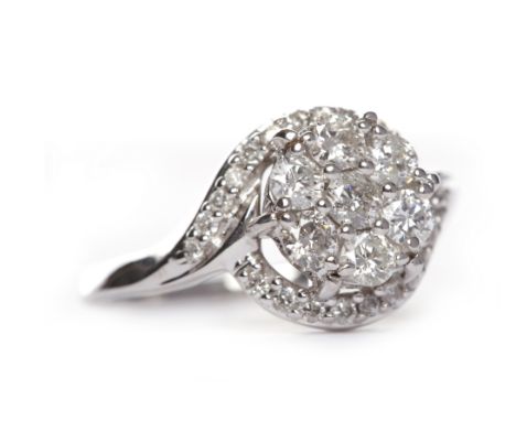 DIAMOND CLUSTER RINGthe diamond daisy cluster bezel set with seven round brilliant cut diamonds, on diamond shoulders, unmark