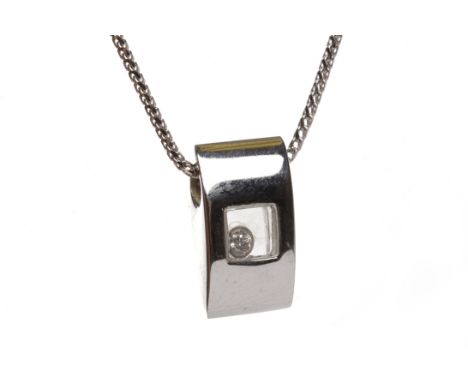 CHOPARD DIAMOND SET PENDANT of elliptical form and set with a single free moving diamond visible behind crystal, 16.5mm high,