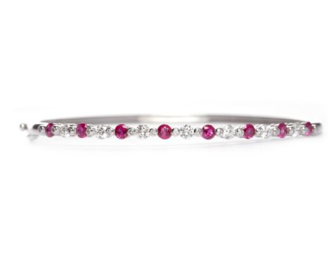 RUBY AND DIAMOND BANGLEset with round brilliant cut diamonds totalling approximately 0.75 carats interspaced by round rubies,
