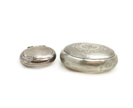 A French silver snuff box,indistinct marks to the lid and body, of oval form with engine turned detail, the hinged cover engr