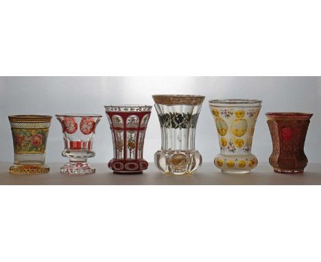 A group of six Bohemian glass spa type beakers,19th century and later, comprising a relief paste gilded example, 11.4cm high,
