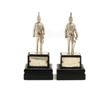 A pair of silver models of fusilier soldiers,by Garrard &amp; Co, London 1982, on wood plinths, 11.5cm highCondition ReportOn